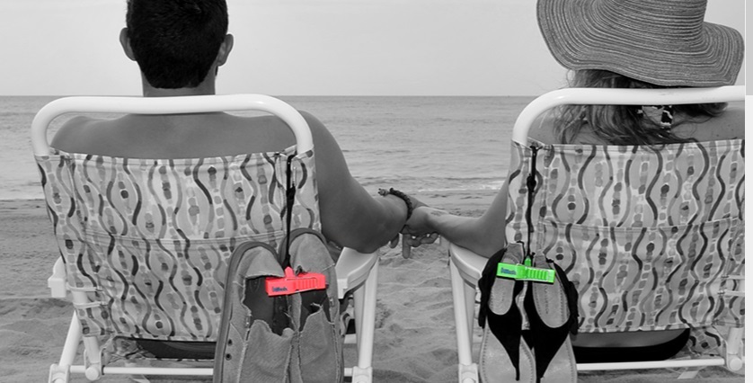a couple relaxing at the beach and using clip and go for sandals